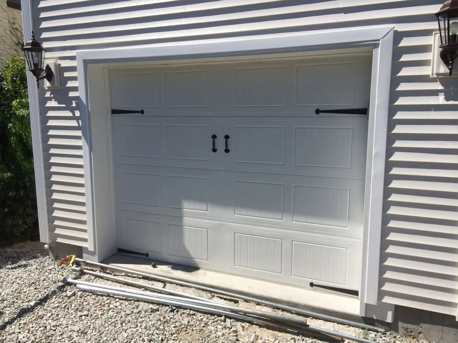 White short-panel carriage door with decorative handles and hinges