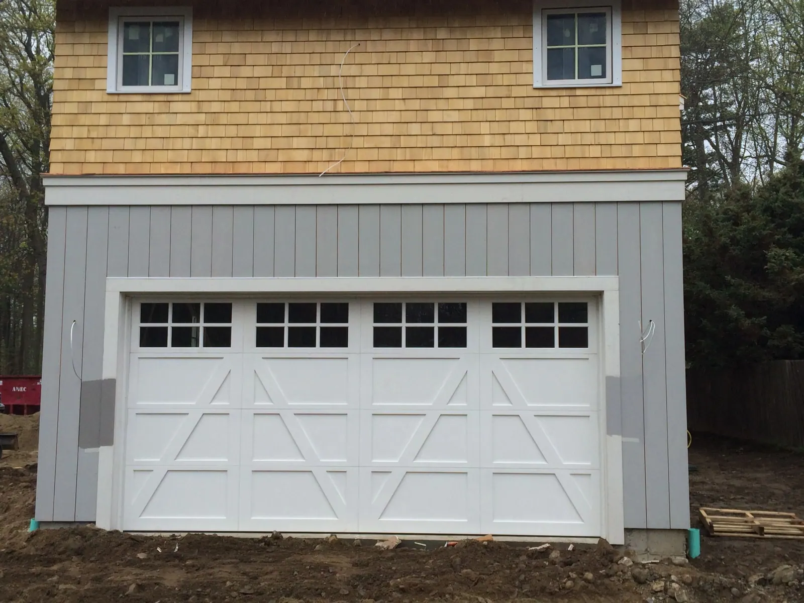 A custom carriage-house door with divided glass installed by Apex Door