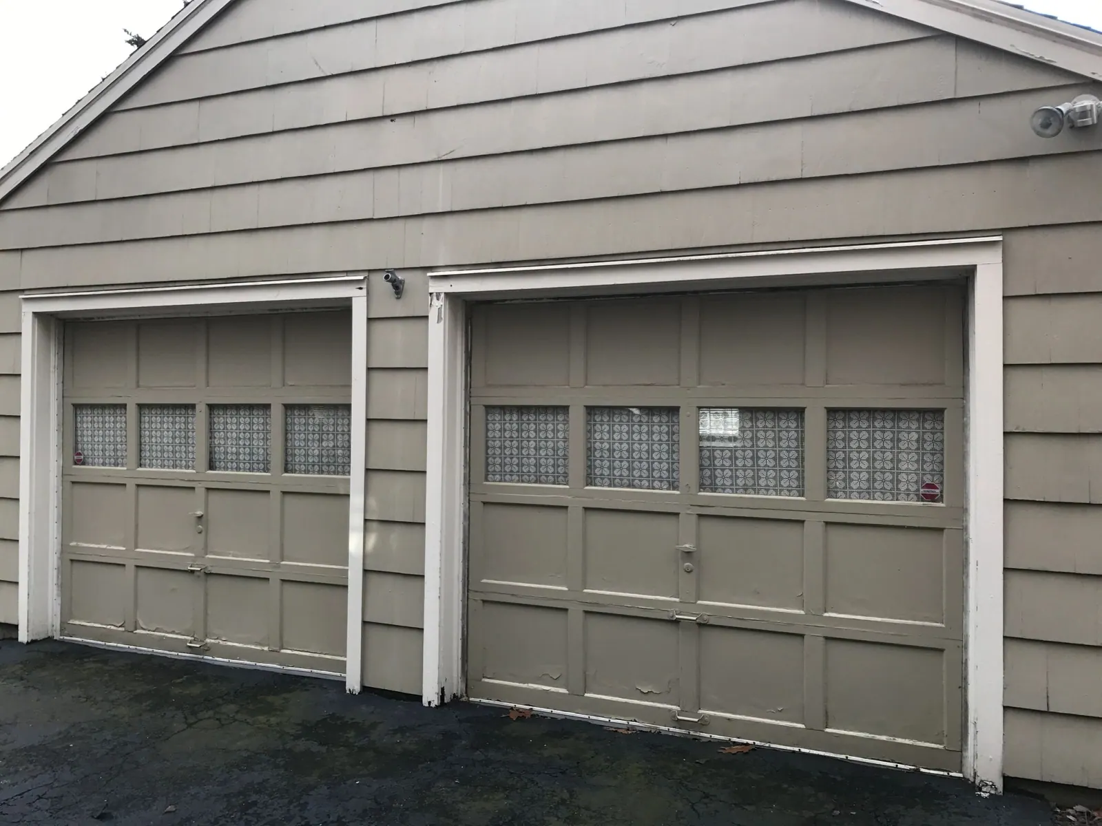 Two white garage doors on a two-car garage