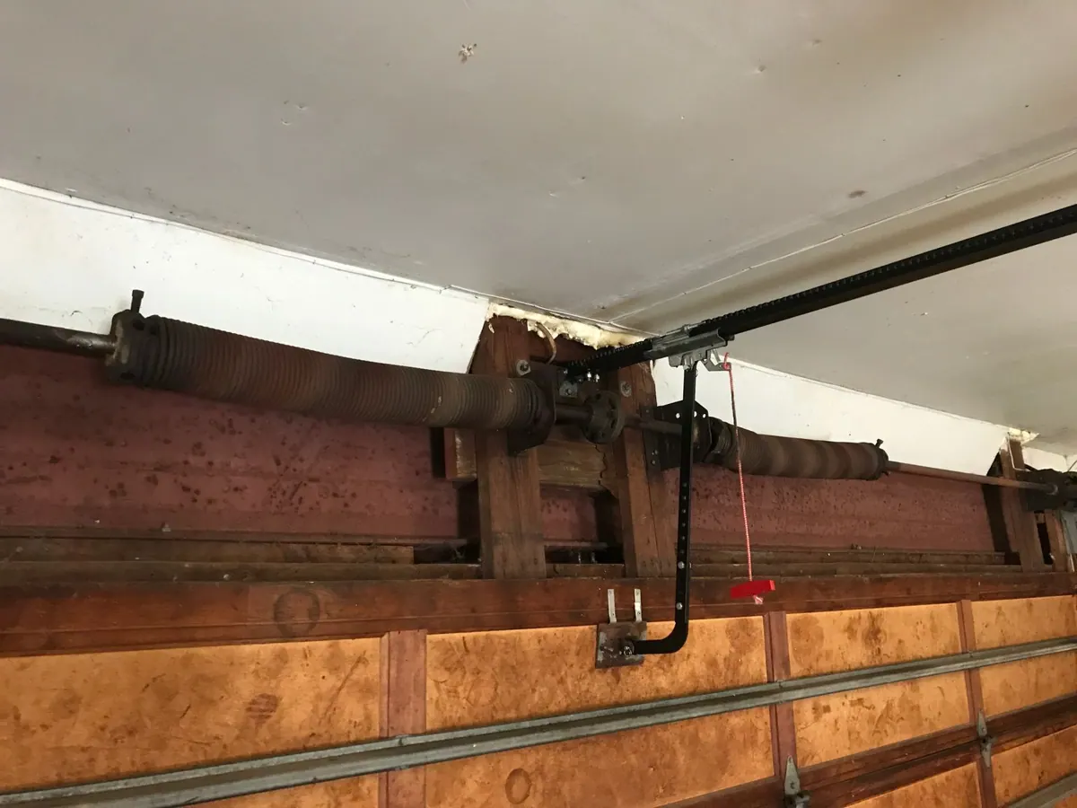 Torsion spring and opener rail after a garage door spring replacement